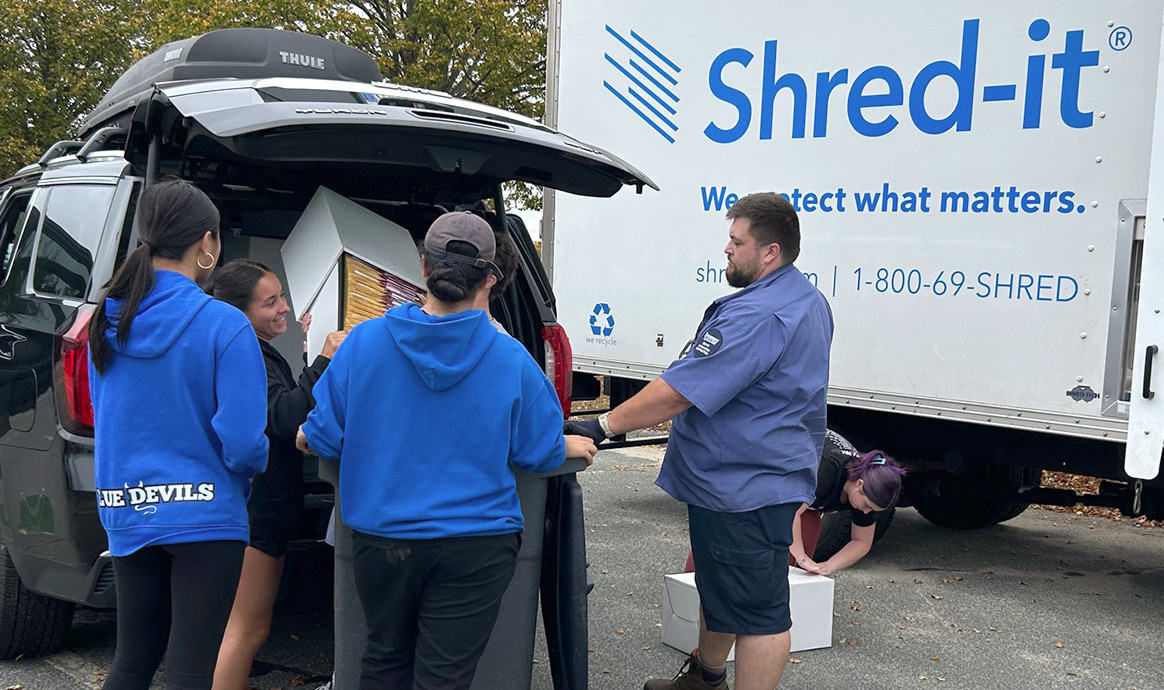 FHS student volunteers assist a community member with their drop-off.