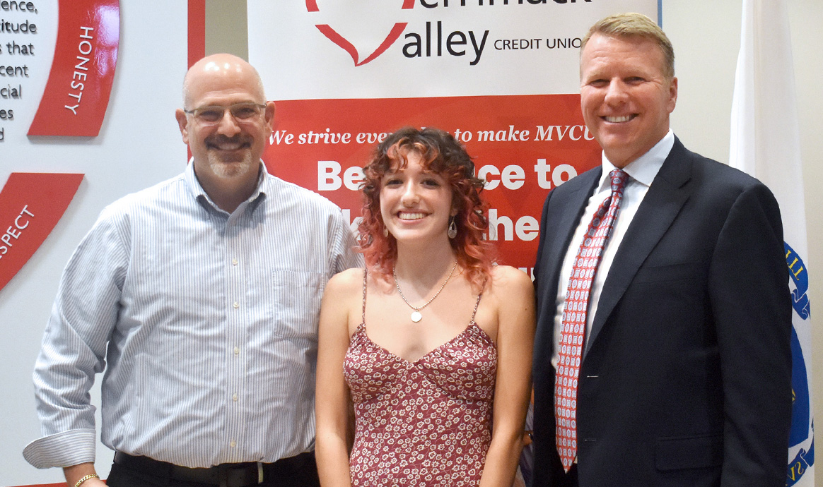 Sienna Gediman of Newburyport, Mass., the 2024 recipient of the Lisa Lewis Goodman Community Spirit Award, smiles between Brad Goodman (left) and MVCU President & CEO John Howard. 